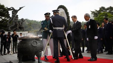 South Korea's new President Moon Jae-In, centre right, offers a wreath at the National Cemetery.