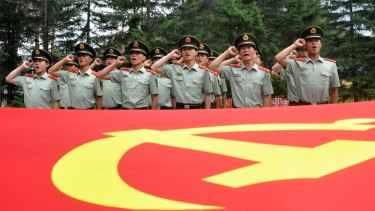 Chinese paramilitary policemen pledge loyalty to the Communist Party as they observe the 94th anniversary of the founding of the Communist Party of China on July 1. 