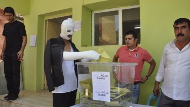 A man wounded in an attack on an HDP rally casts his vote in Turkish parliamentary elections.