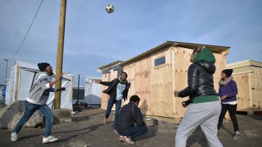 Migrants play handball in the camp known as the "New Jungle" in Calais on December 3. 
