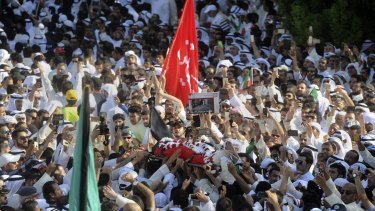 Thousands of Sunnis and Shiites from across the country take part in a mass funeral procession on Saturday for the 27 people killed in a suicide bombing.
