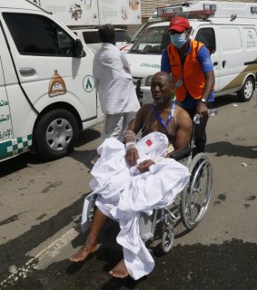 A rescue worker attends to a man injured in the stampede in Mina, Saudi Arabia.