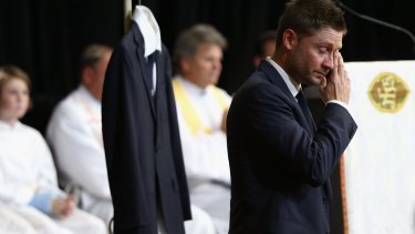 'I keep looking for him, I know it's crazy': Michael Clarke fights through tears as he speaks at the service. 