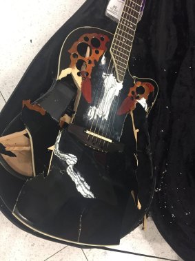 Jon English posted a photo of his smashed-up Ovation guitar after he collected it from a baggage carousel at Sydney Airport.