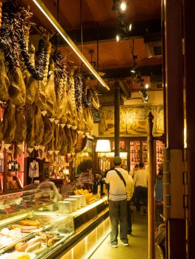 A tapas bar with hanging jamon over the counter is part of the city's top drinking and dining scene.