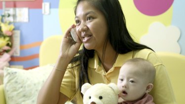 Pattaramon Chanbua, 21, with her son Gammy in 2014. The Baby Gammy scandal led to Thailand closing surrogacy clinics across the nation and driving clients to Cambodia. 