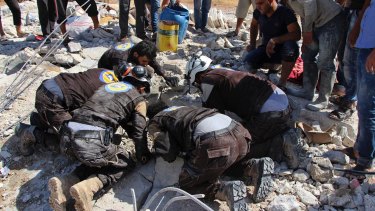 The Syrian Civil Defense White Helmets search in the rubble after airstrikes hit in Khan Sheikhou.