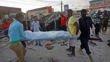 Somalis carry away the body of a civilian killed in a car bomb attack in Mogadishu on Thursday.