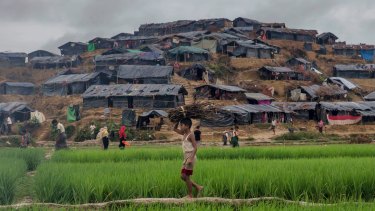 A Rohingya Muslim boy carries firewood towards his shelter in Kutupalong refugee camp in Bangladesh on Monday.