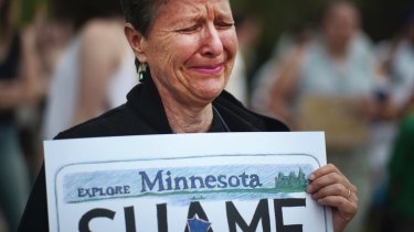 Reverend Laurie Bushbaum, a Unitarian minister, carries a sign that showed how she feels about the Yanez verdict during a demonstration on Sunday.