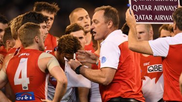 Crisis measures: An increasingly desperate John Longmire addresses the Swans during their semi-final loss to the Cats. 