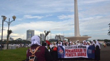 Female protesters against Ahok gather at the national monument in Jakarta.