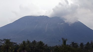 Mount Agung spews volcanic ash into the air at Selat village in Karangasem, Bali, on Saturday.