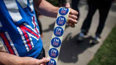"I'm In" stickers handed to pedestrians in London on Monday. 