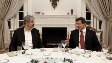 Turkey's then prime minister Ahmet Davutoglu, right, and Hamas leader Khalid Mishal speak during a dinner in Ankara in December 2015. 