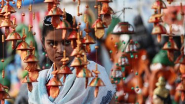 An Indian woman looks at decorative items on sale ahead of Diwali Hindu festival in Hyderabad.
