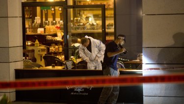 Israeli police officers examine the scene of the shooting.