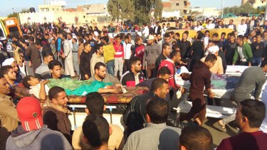 Injured people are evacuated from the scene of a militant attack on a mosque in Bir al-Abd in the northern Sinai Peninsula on Friday.