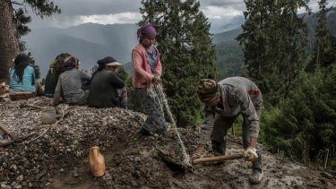 Indian labourers hired by their country's military work on a road improvement project in Haa, Bhutan, near a border area claimed by both India and China.