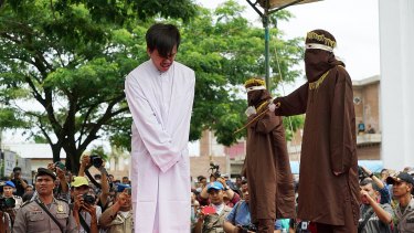 The masked men took turns to deliver the lashes  - 83 in the end - with a cane according to Aceh's sharia-inspired laws.