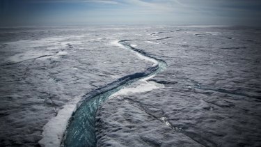 Meltwater flows along a glacial river on the Greenland ice sheet last July.