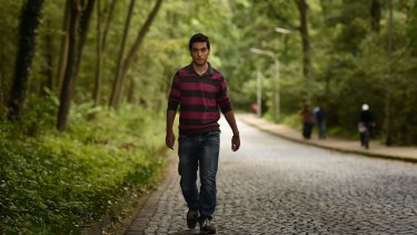 Ali Deeb from Latakia in Syria walks towards the refugee camp he is staying in near Braunschweig, Germany.