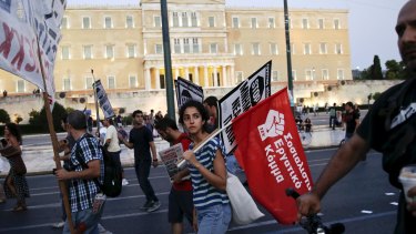 Protesters march during an anti-bailout demonstration in front of the parliament building in Athens on Thursday.