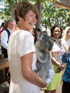 Margie Abbott, wife of  Tony Abbott, holds a koala on a spouse visit to Lone Pine Sanctuary.