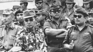 Indonesia's Major-General Suharto, in camouflage uniform, at the funeral for six generals killed by rebels in the abortive attempt to overthrow then president Sukarno in 1965. The coup attempt led to nationwide massacres. 
