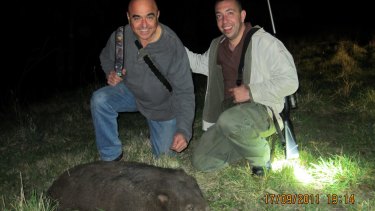 Tony Azzi,  left, and Nick Karagiannis with a dead wombat.