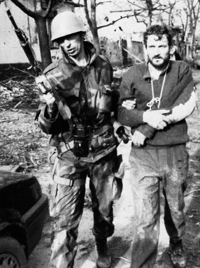 A Yugoslav soldier leads a captured Croatian guardsman in eastern Croatia in 1991.