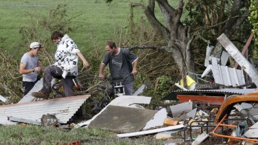 Jason Ferguson finds his motorbike which was washed away by the flood in Dungog, NSW.