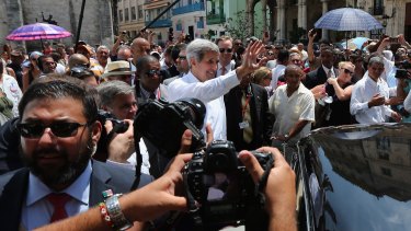 US Secretary of State John Kerry surrounded by a wall of Cuban and American security agents as he walks through Havana.