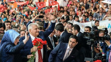 New Turkish prime minister, Binali Yildirim, and his wife, Semiha Yildirim, arrives at the ruling AK Party's congress in Ankara.
