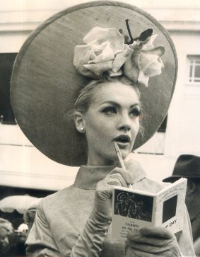 At the 1964 Melbourne Cup at Flemington, Margaret Wood of Essendon looks thoughful in her skimmer, highlighted by roses.
