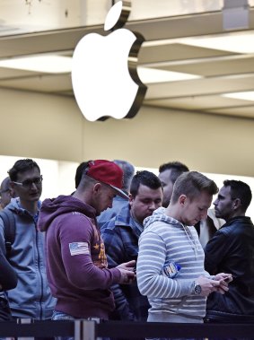 Customers wait in front of the Apple store in Oberhausen, Germany, as Apple Inc. launches worldwide the sales of the new iPhones on early Friday, Sept. 25, 2015. People camped in front of the store for several days to be the first getting the new iPhone 6s.