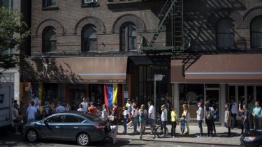 Venezuelan living in the United States wait in line outside of a polling station to cast their ballots during a symbolic Venezuelan plebiscite in New York on Sunday.
