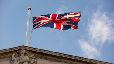 A British Union Flag, also known as a Union Jack, flies above the Bank of England.
