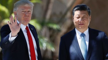 President Donald Trump and Chinese President Xi Jinping pause for photographs at Mar-a-Lago, on Friday.