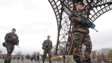 French army soldiers patrol under the Eiffel Tower in Paris on Tuesday January 13.