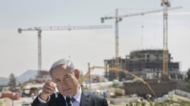 Israeli Prime Minister Benjamin Netanyahu visits a construction site in the east Jerusalem settlement of Har Homa, where he vowed to continue building.