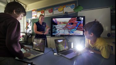 Switched on: North Fitzroy Primary School teacher Rebecca Martin has embraced gaming technology in her class. Students Eamon, left, and Hemi, enjoy building worlds in "Minecraft".  