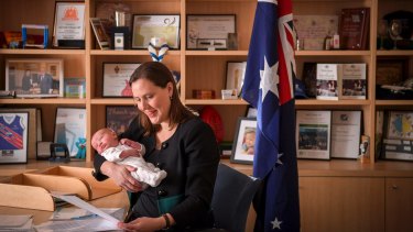 Kelly O'Dwyer in her office with her newborn son.