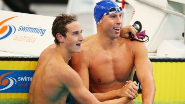 Cameron McEvoy and Grant Hackett celebrate following the men's 200m freestyle final at Sydney Olympic Park Aquatic Centre.