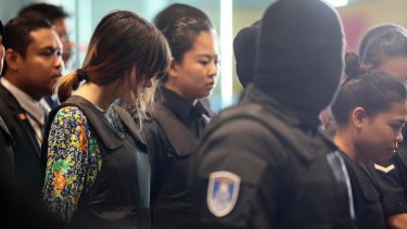 Indonesian Siti Aisyah, right, and Vietnamese Doan Thi Huong, second left, are escorted by police at Kuala Lumpur International Airport on Tuesday.