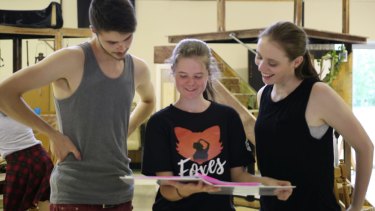 Foxes director Rachel Pengilly, centre, shares notes with actors Tanner Clark, left and Katherine Berry on the set.