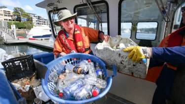 Clean Up Australia Day volunteers battle the bottle scourge in Sydney's waterways in March this year.