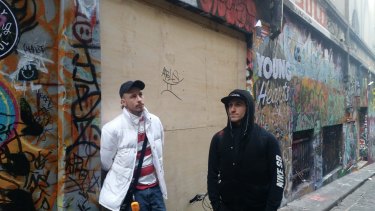 Homeless man Jubs, left, with a friend, says half his possessions have been locked up after  Hosier Lane alcoves were boarded up.