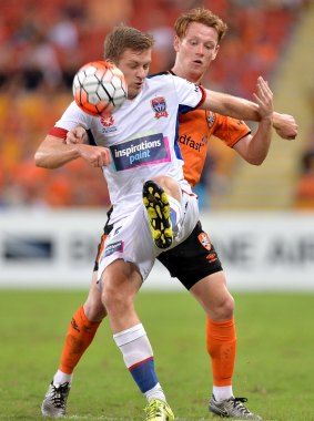 Ryan Kitto of the Jets is challenged by Corey Brown of the Roar.