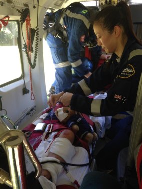 CareFlight's Dr Sunny Yoo treats one of the injured children before flying to Westmead.